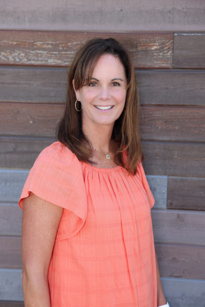 Julie Robbins Certified Life Coach Certified 9D Breathwork Facilitator in Mequon, WI portrait peach dress Bio photo